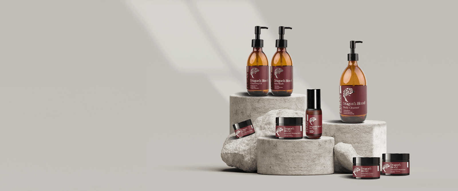 A bottle of Dragon’s Blood face serum with botanical ingredients on a background.