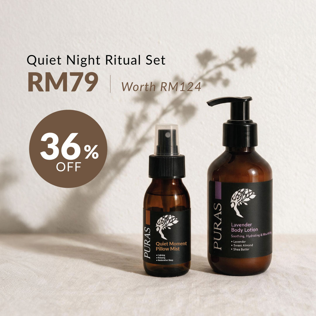 Puras Quiet Night Ritual Set featuring a lavender body lotion bottle and a quick moment pillow mist bottle in amber glass with black labels, displayed on a textured white surface.