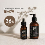 Puras Quiet Night Ritual Set featuring a lavender body lotion bottle and a quick moment pillow mist bottle in amber glass with black labels, displayed on a textured white surface.