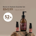 Three facial care products from Tuaras arranged on rocks against a beige background, with promotional text reading 'Revive & Hydrate Essential Set', 'RM199 | Worth RM418', and '52% OFF'. The set includes a large amber pump bottle labeled Dragon's Blood Face Wash and two smaller amber dropper bottles.