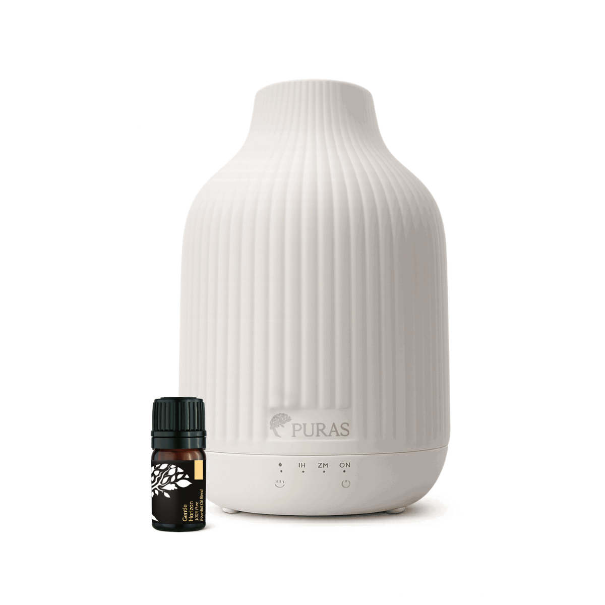 A white ribbed ceramic diffuser bottle with a small dark amber essential oil bottle placed in front, shown on a clean white background. The diffuser has the PURAS logo printed on the front.