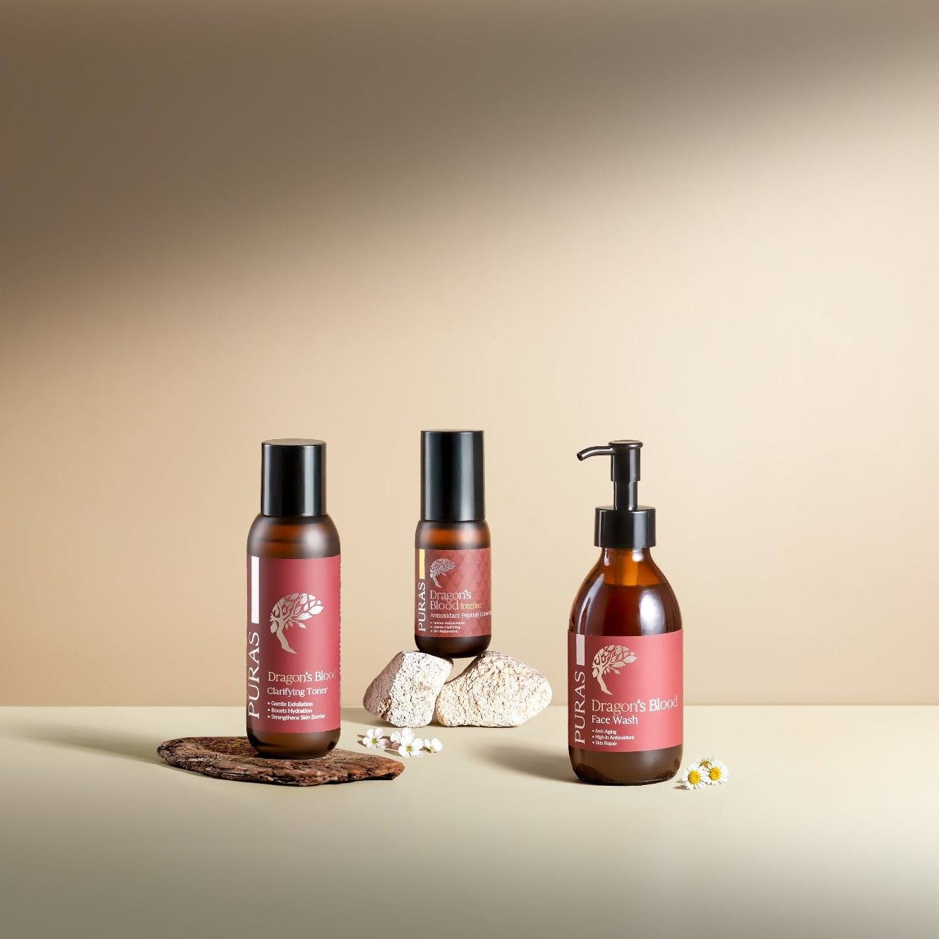 Three DB skincare bottles with red labels on a beige background