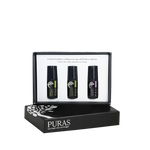 Puras non-toxic skin care roller-on set in a black presentation box, featuring three small black bottles with green and purple labels on a white insert card, with the main black box displayed in front on a white background.