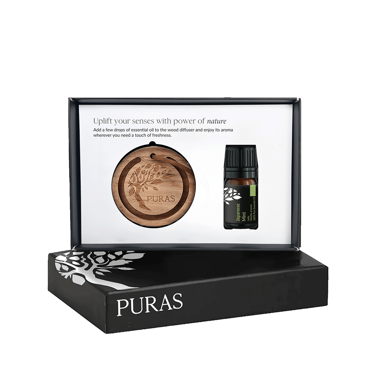 Puras essential oil gift set in a black presentation box, featuring a round wooden diffuser tray and a small dark glass essential oil bottle with a black cap, shown against a white background.