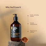 Puras Citrus Geranium body wash bottle on a wooden block with a brown background