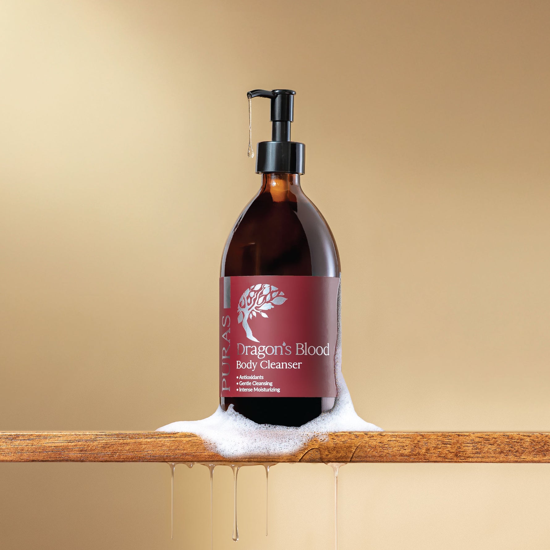 Bottle of 'Dragon's Blood' body cleanser with a pump with texture on a wooden surface against a beige background