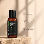 An amber bottle of PURAS Revival Conditioner with a black cap and black label stands on a stone surface against a warm beige background with soft shadows. Text on the right lists benefits: intensive, restorative nourishment; soft, deeply hydrated, tangle-free hair; healthier-looking, shinier strands.